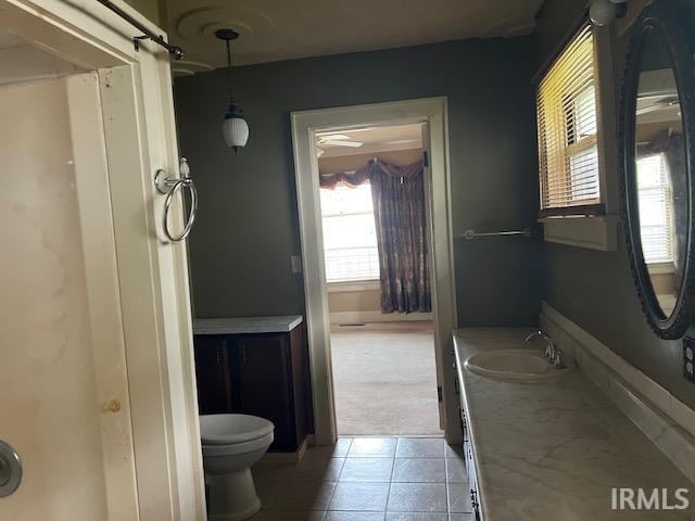 bathroom featuring tile patterned floors, vanity, and toilet