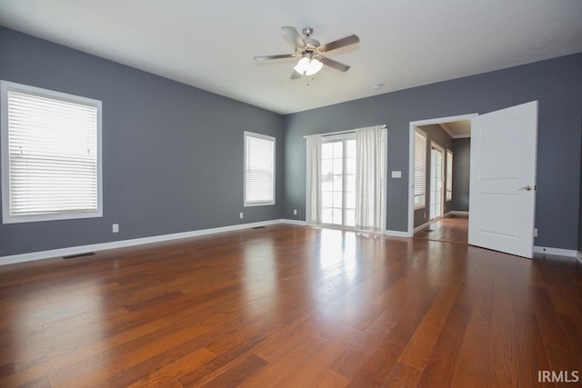 spare room with ceiling fan and dark hardwood / wood-style flooring