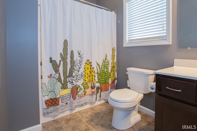 bathroom featuring tile patterned flooring, vanity, and toilet