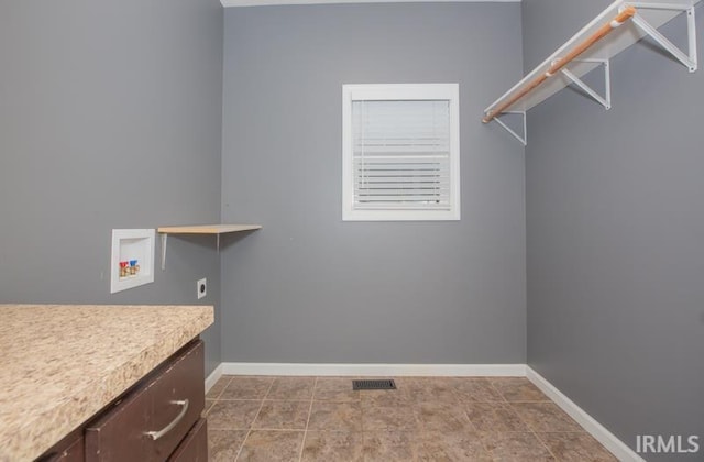 clothes washing area featuring visible vents, baseboards, hookup for an electric dryer, and hookup for a washing machine