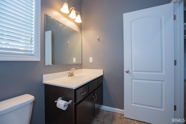 bathroom featuring tile patterned floors, vanity, and toilet