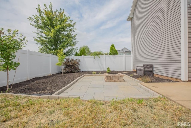 view of patio with an outdoor fire pit and a fenced backyard
