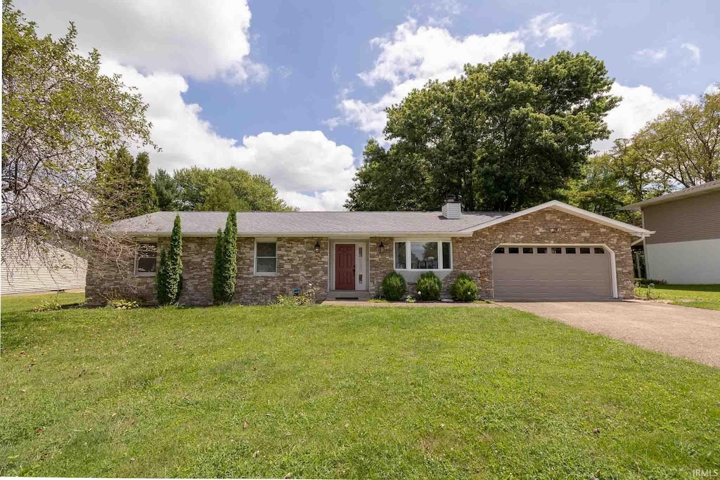 ranch-style house featuring a front yard and a garage