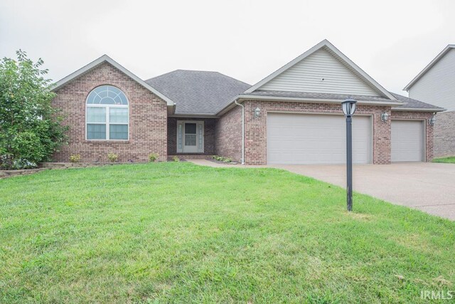 single story home featuring a garage and a front yard