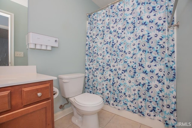 bathroom with vanity, toilet, curtained shower, and tile patterned flooring