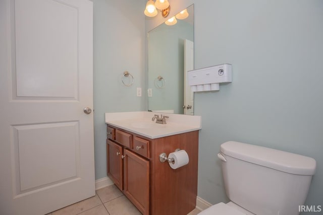 bathroom featuring vanity, tile patterned floors, and toilet