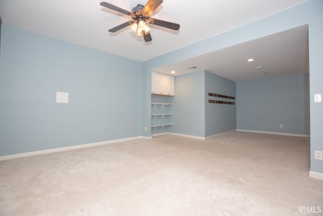 unfurnished room with ceiling fan and light carpet