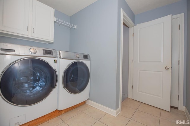 laundry area featuring cabinets, independent washer and dryer, and light tile patterned floors