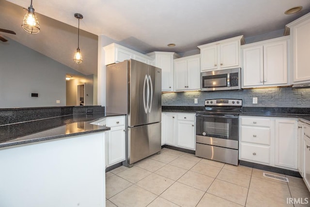 kitchen featuring white cabinetry, light tile patterned floors, appliances with stainless steel finishes, pendant lighting, and backsplash