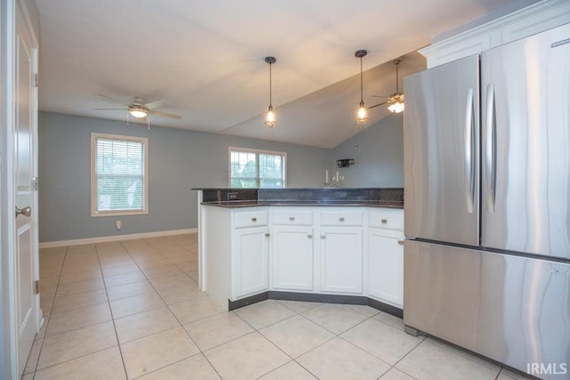 kitchen with white cabinetry, stainless steel refrigerator, a wealth of natural light, pendant lighting, and ceiling fan