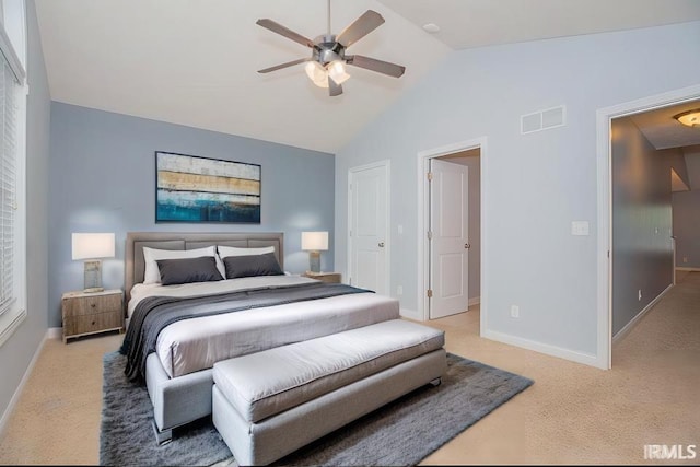 bedroom with light carpet, vaulted ceiling, and ceiling fan