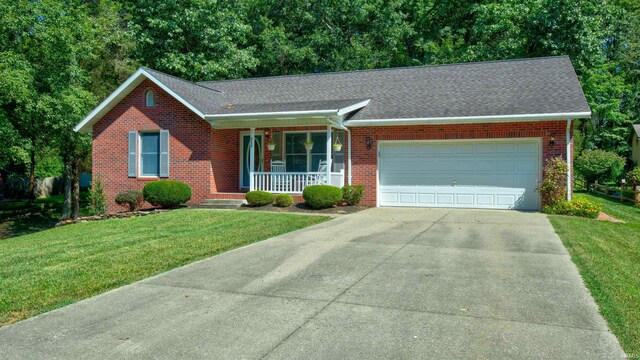 ranch-style house with a front lawn, covered porch, and a garage