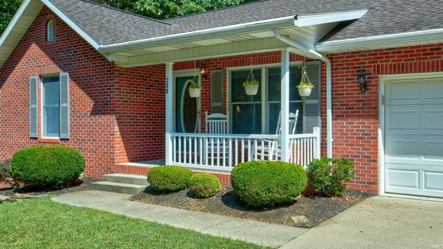 property entrance with a garage and covered porch