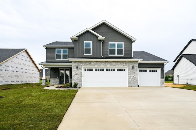 view of front of house featuring a front lawn and a garage