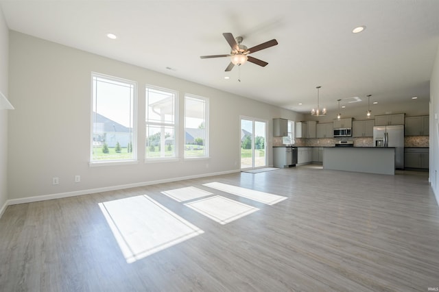 unfurnished living room with ceiling fan and light hardwood / wood-style floors