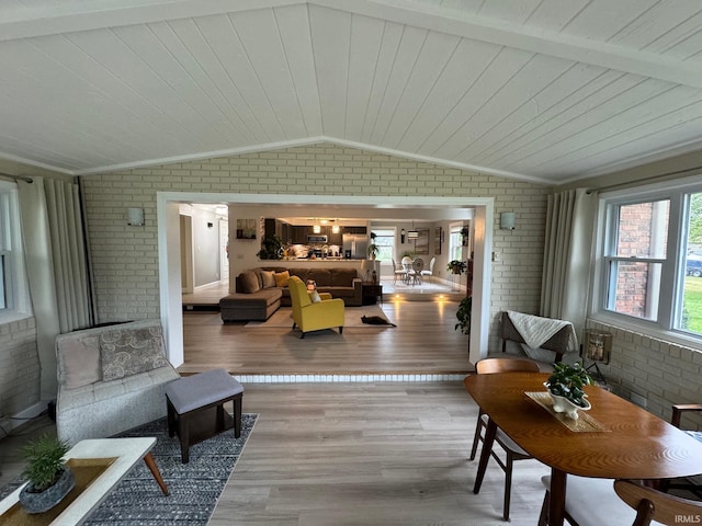 sunroom featuring lofted ceiling and wood ceiling