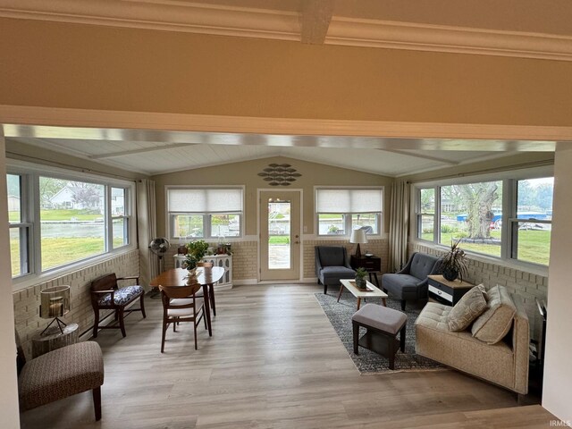 doorway to outside with hardwood / wood-style floors and crown molding