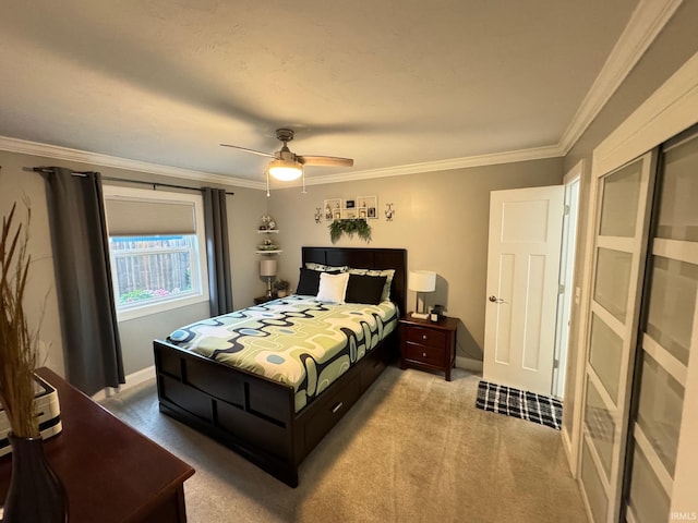 carpeted bedroom featuring ceiling fan and crown molding