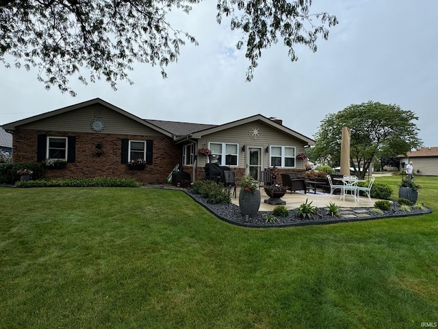 rear view of house with a lawn and a patio