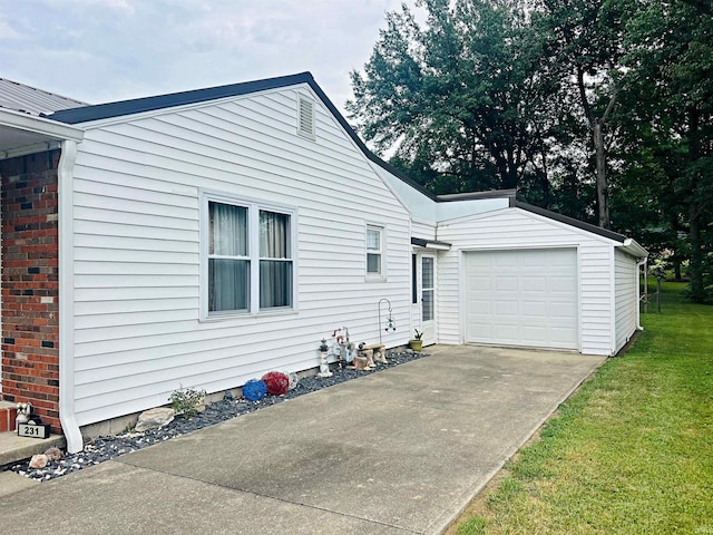 exterior space with an attached garage, driveway, and a lawn