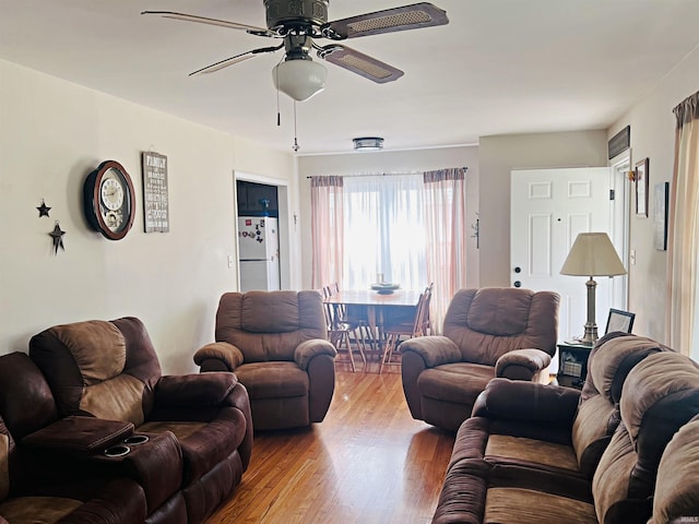 living room featuring ceiling fan and wood finished floors