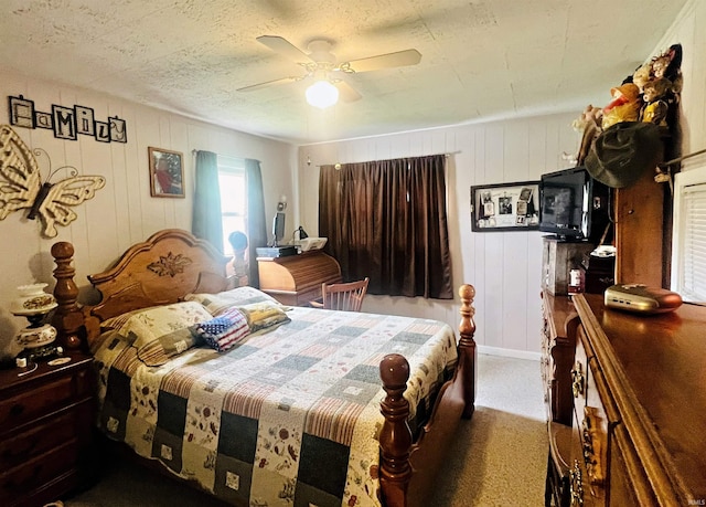 carpeted bedroom with a textured ceiling and ceiling fan