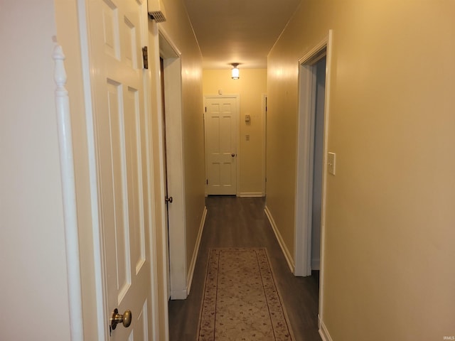 corridor featuring dark hardwood / wood-style flooring