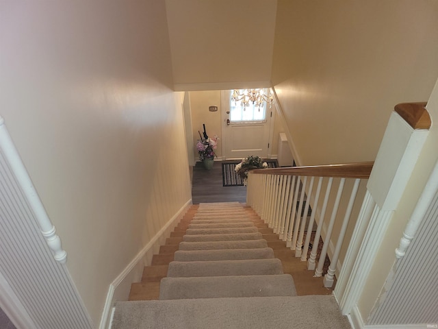 stairway with an inviting chandelier