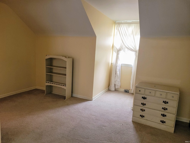 additional living space with vaulted ceiling and light colored carpet