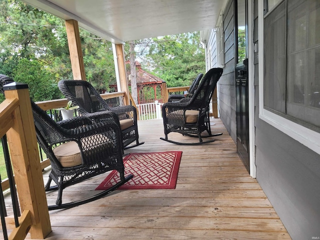 deck with a gazebo and a porch