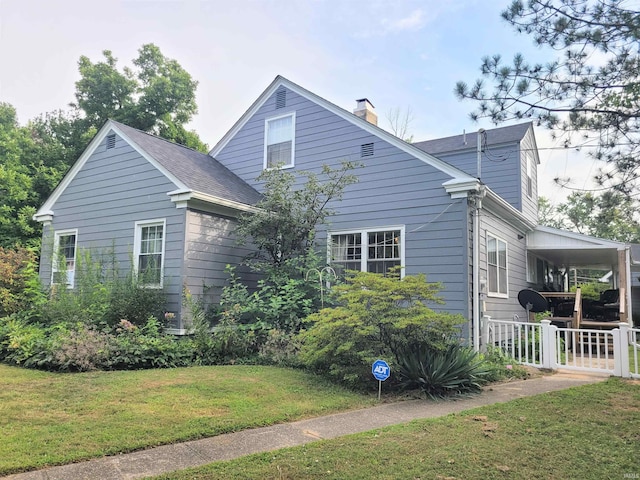 view of property exterior featuring a porch and a yard