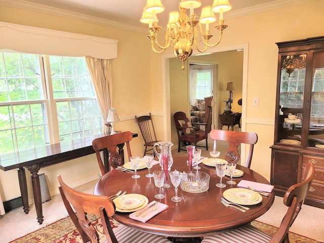 dining area with crown molding, a wealth of natural light, and an inviting chandelier