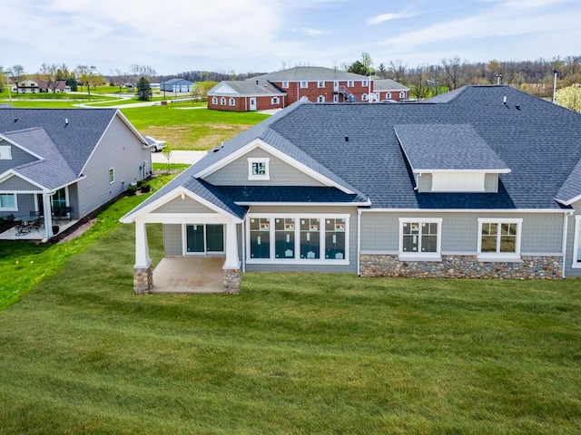 rear view of property featuring a yard and a patio