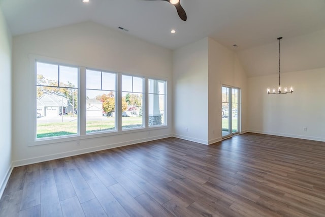 unfurnished room featuring high vaulted ceiling, dark wood-type flooring, and ceiling fan with notable chandelier