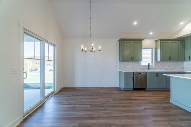 kitchen featuring pendant lighting, dark wood-type flooring, lofted ceiling, and stainless steel dishwasher