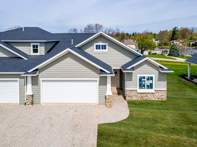 craftsman-style home featuring a front yard and a garage