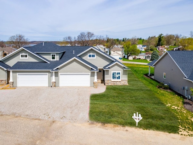 view of front of property with a front lawn and a garage