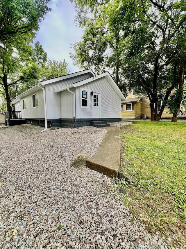 view of side of home featuring a yard