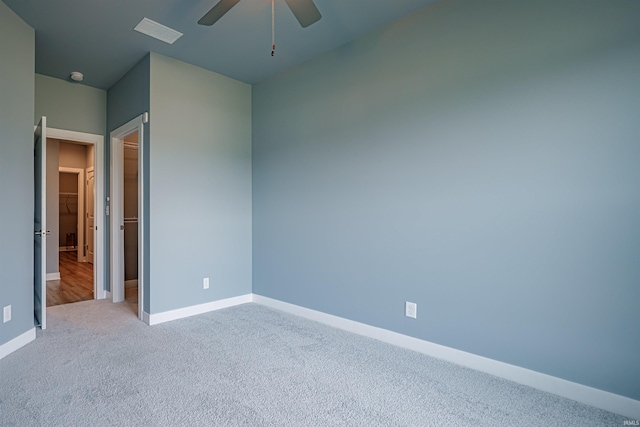 unfurnished bedroom featuring light colored carpet and ceiling fan