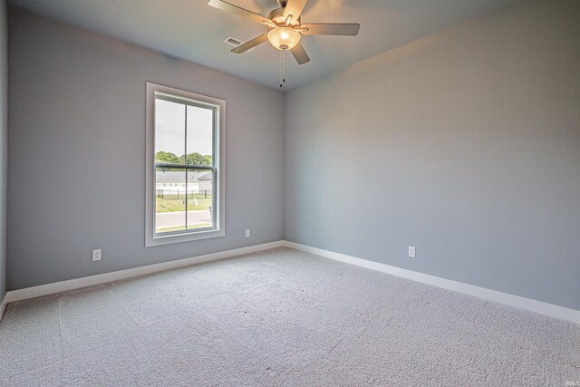 spare room featuring ceiling fan and carpet floors