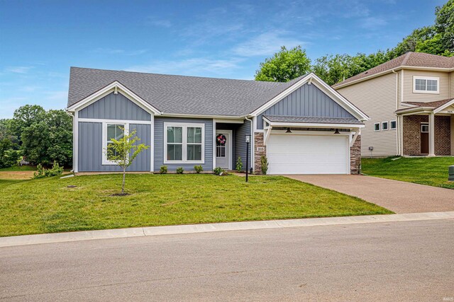 view of front of home featuring a garage and a front yard