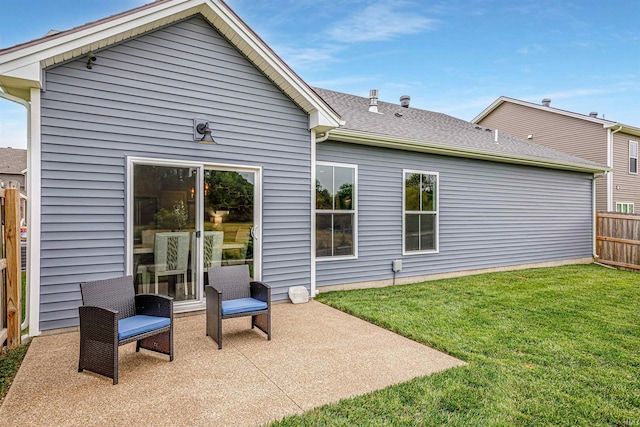 rear view of property featuring a yard and a patio area