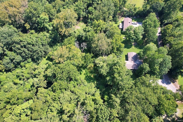 birds eye view of property with a view of trees