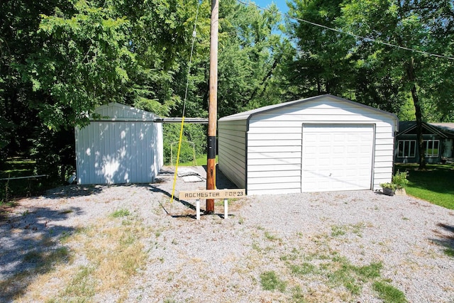 detached garage with a storage shed