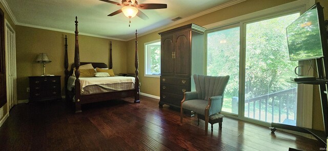 bedroom featuring a ceiling fan, wood finished floors, visible vents, baseboards, and crown molding