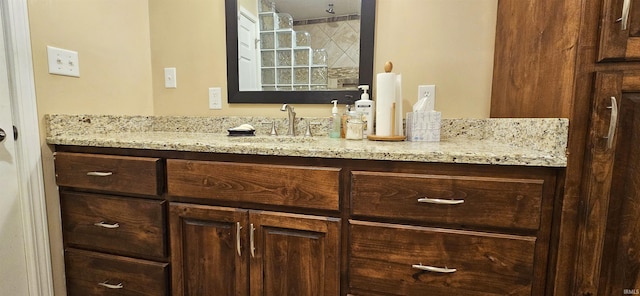 full bath with vanity and a tile shower