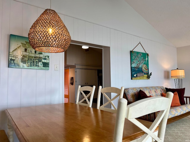 dining room with vaulted ceiling and wood-type flooring