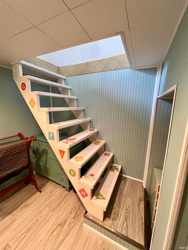 staircase with hardwood / wood-style flooring