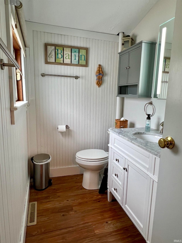 bathroom featuring hardwood / wood-style floors, toilet, and vanity