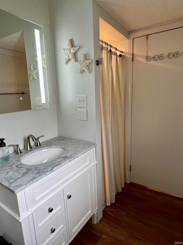 bathroom featuring hardwood / wood-style floors and vanity